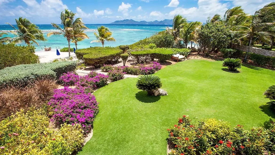 White two-story luxury villa with a swimming pool and mountain landscape.