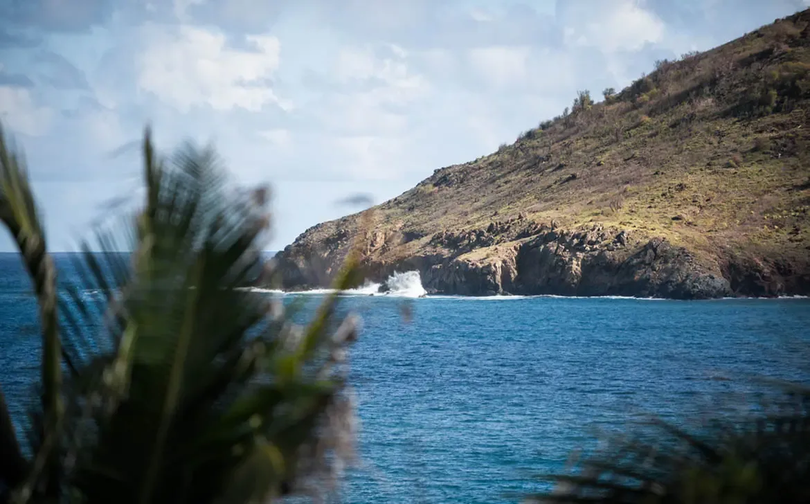 Discover the dramatic coastline of St. Barths, where rugged cliffs meet the powerful Atlantic waves, just moments from your private villa in Gouverneur.