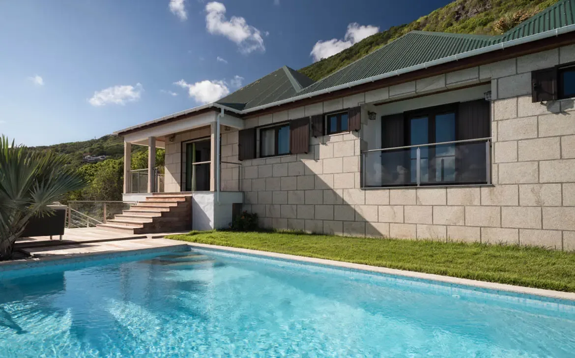 The striking stone facade and refreshing private pool of Villa Gem-Palm Springs create a sanctuary of Caribbean luxury.