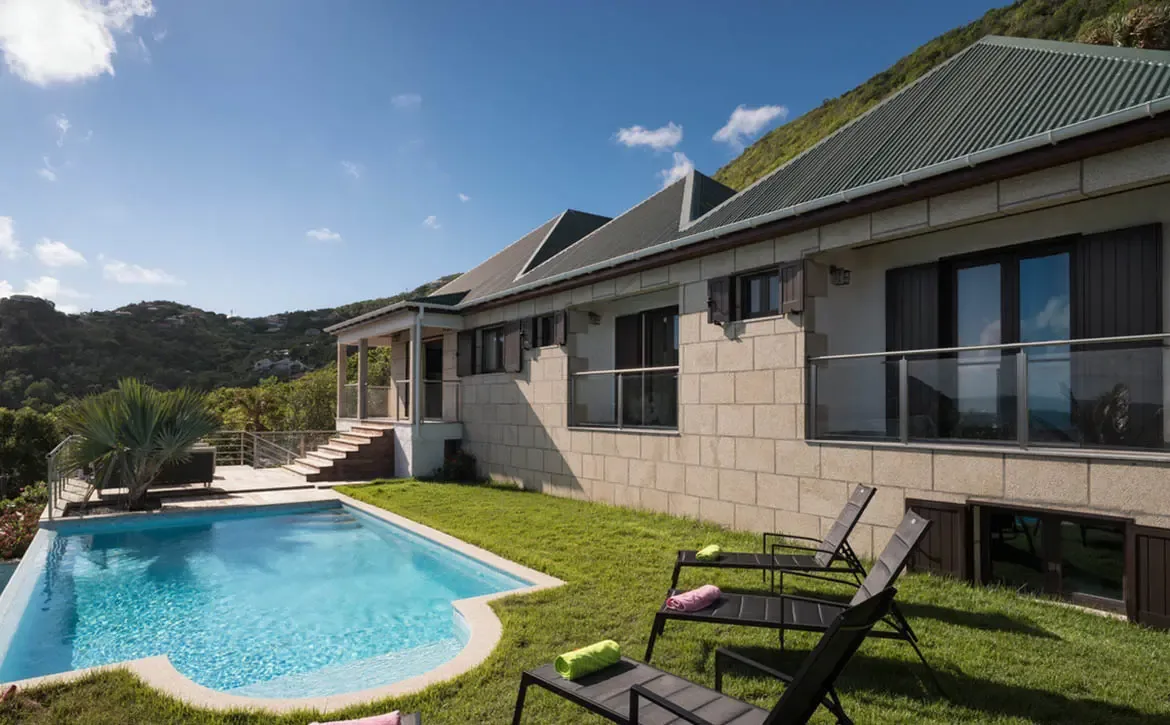 The architectural elegance of Villa Gem is on full display from the pool terrace, harmoniously blending stone craftsmanship with tropical luxury.