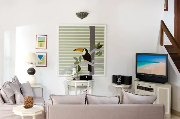 Art-filled living space with tropical toucan artwork — where modern design meets island character.