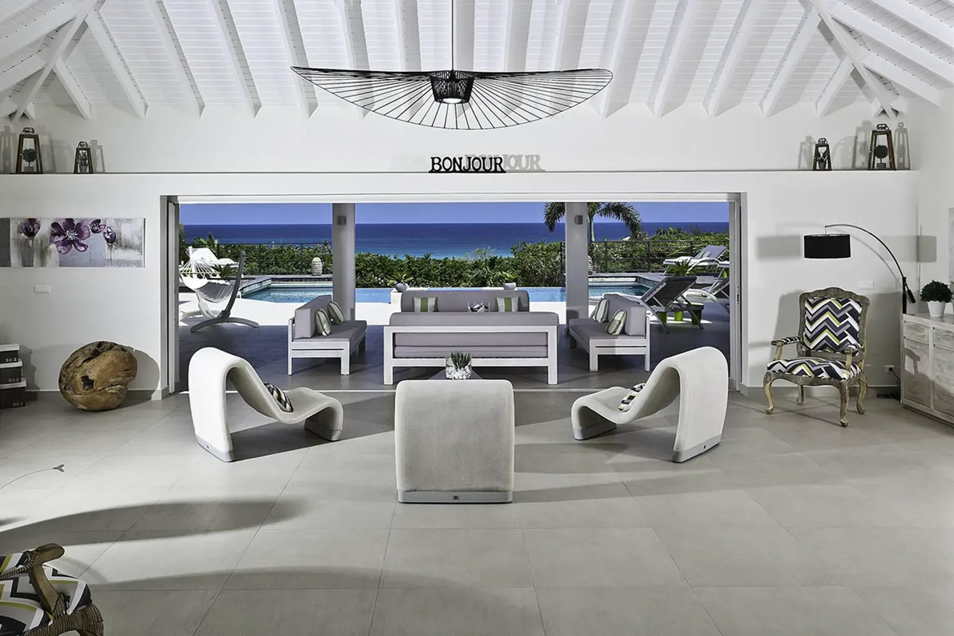 Living room opening to pool terrace and ocean views.