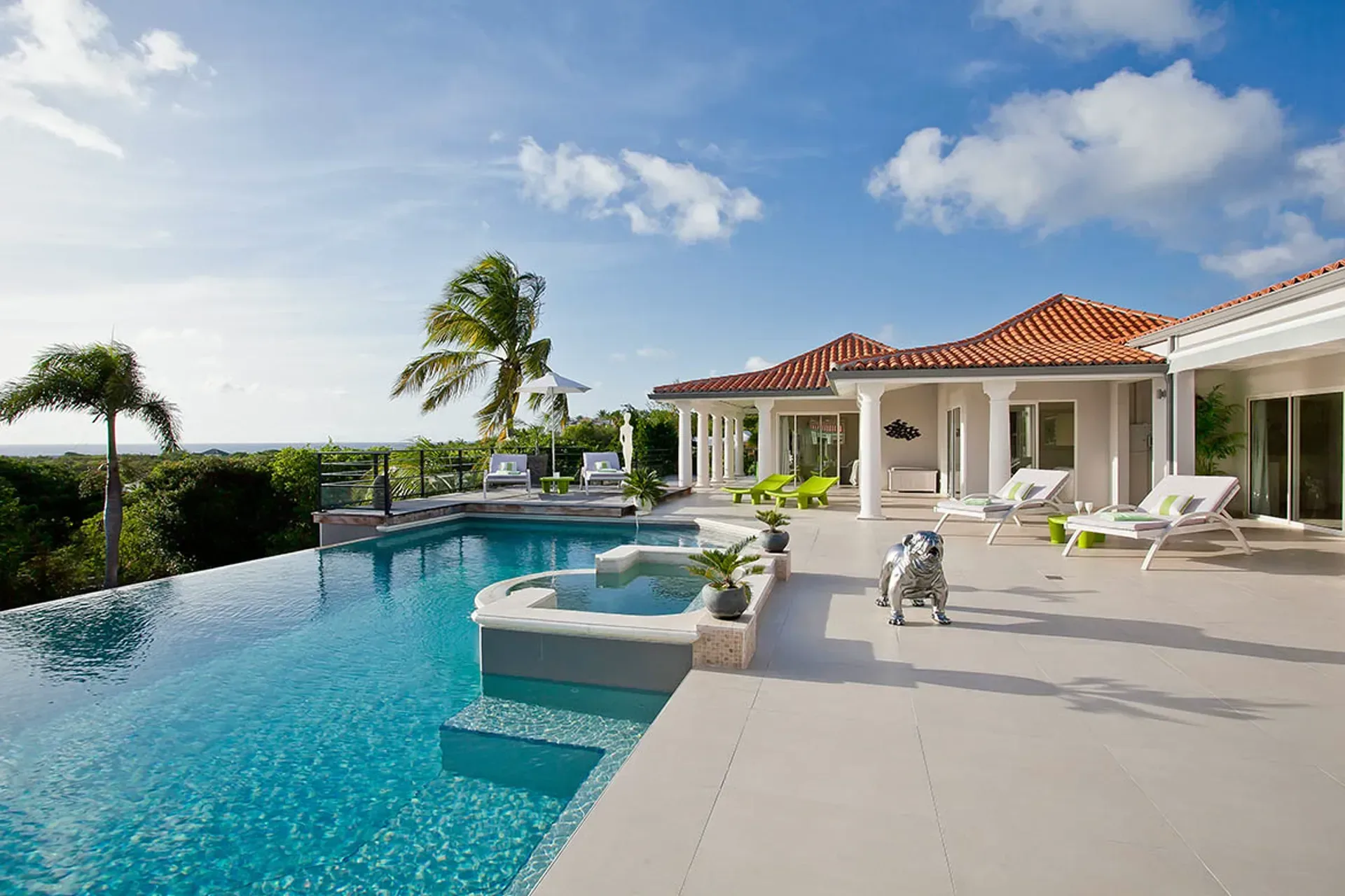 Infinity pool with integrated jacuzzi and panoramic ocean views.