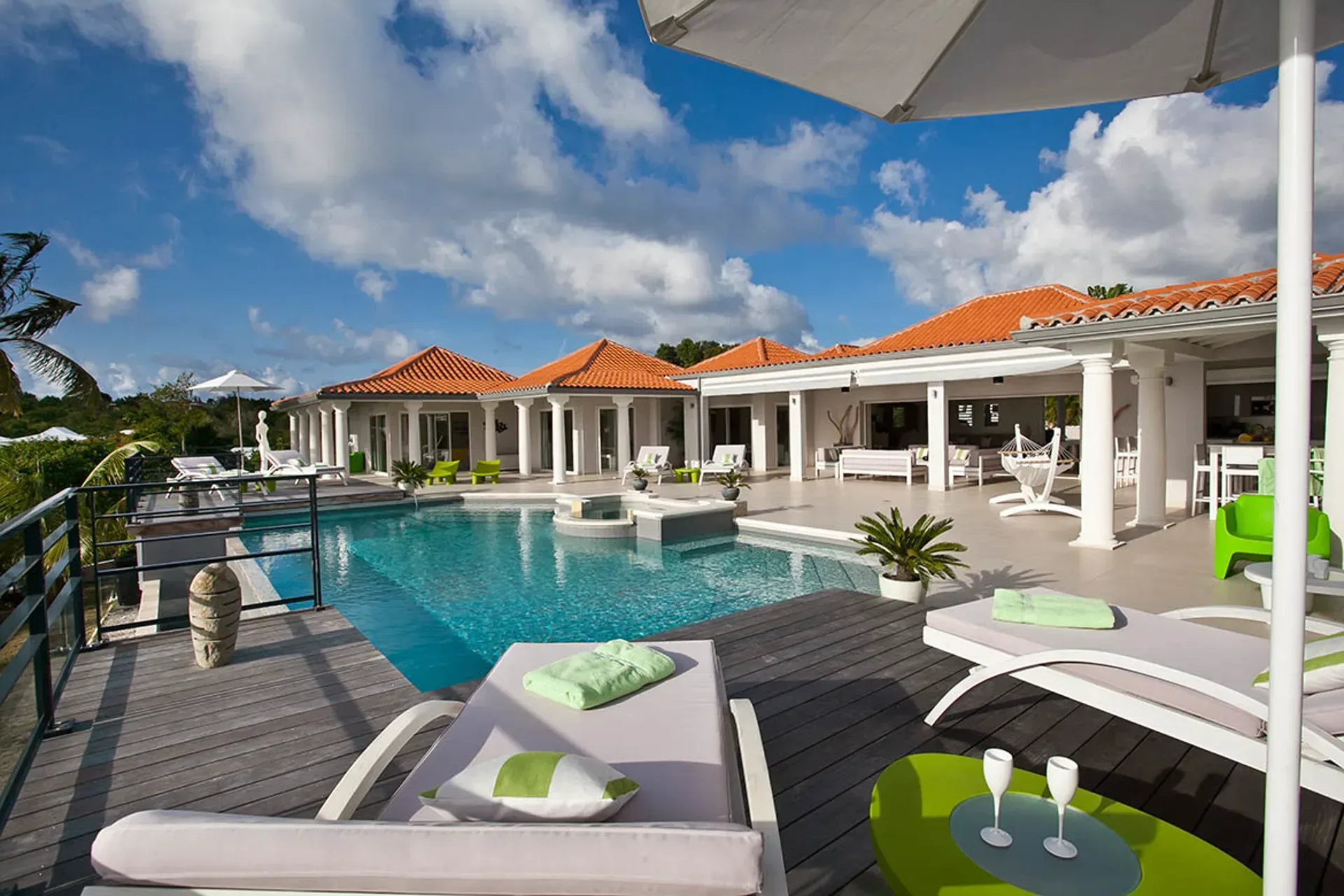 Pool with Mediterranean architecture and terracotta roofs.