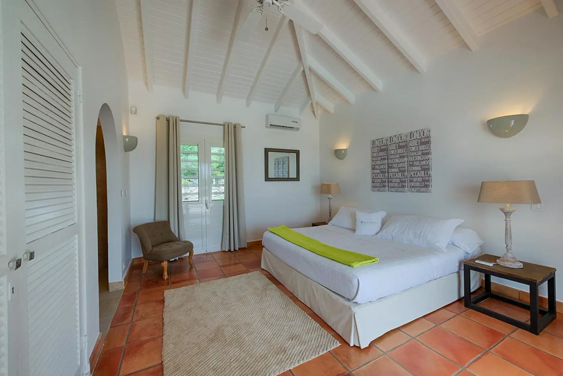 Wake up in a bright airy bedroom with warm terracotta floors.